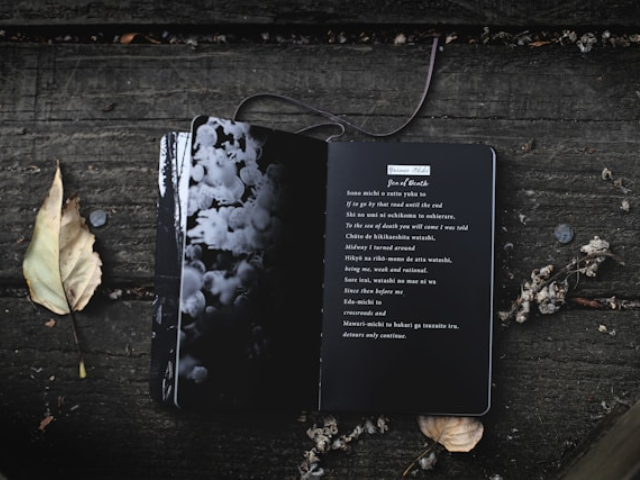 a book of poems with white words on black pages to illustrate the power of poetry to help us during dark times.
