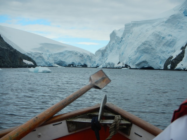 photo of a boat on the sea approaching two glaciers to illustrate the importance of theme.