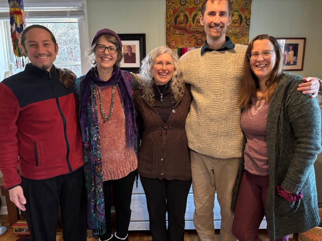 Photo of a group of five middle-aged white men and women standing arm-in arm, all smiling, to illustrate beginners mind and your writing voice
