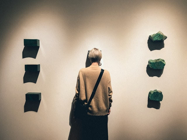 Photo of woman staring at a wall with green blocks on either side of her to illustrate human design potential