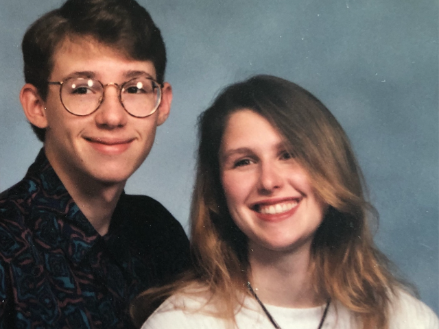 Photo illustrating the limits of empathy, with my brother Joe on the left, a white young man with short brown hair wearing glasses and a dark shirt, and me on the right at age 20, a young white woman with long brown hair, wearing a white shirt