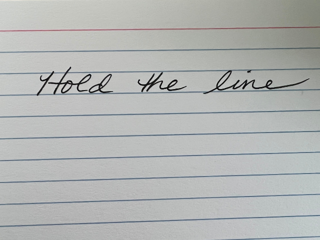 Photo fa notecard with the words hold the line written in cursive to illustrate how art saves lives